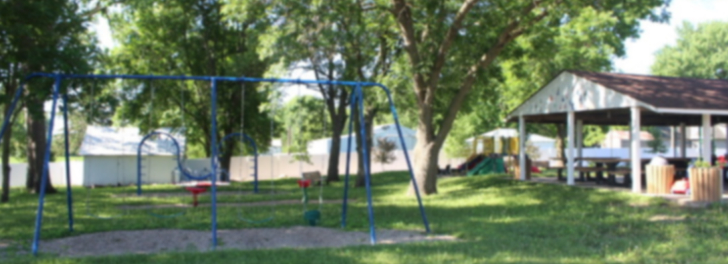 Swingset and park shelter in a city park
